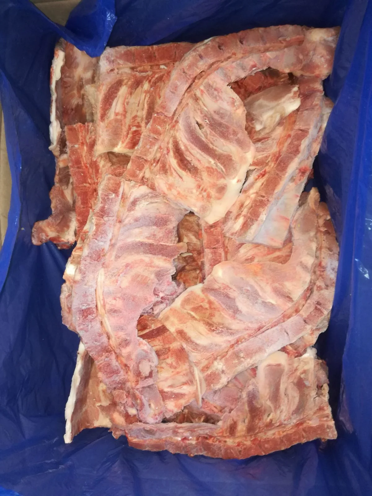 Frozen pork neck bones – open 10 kg carton with inner bag